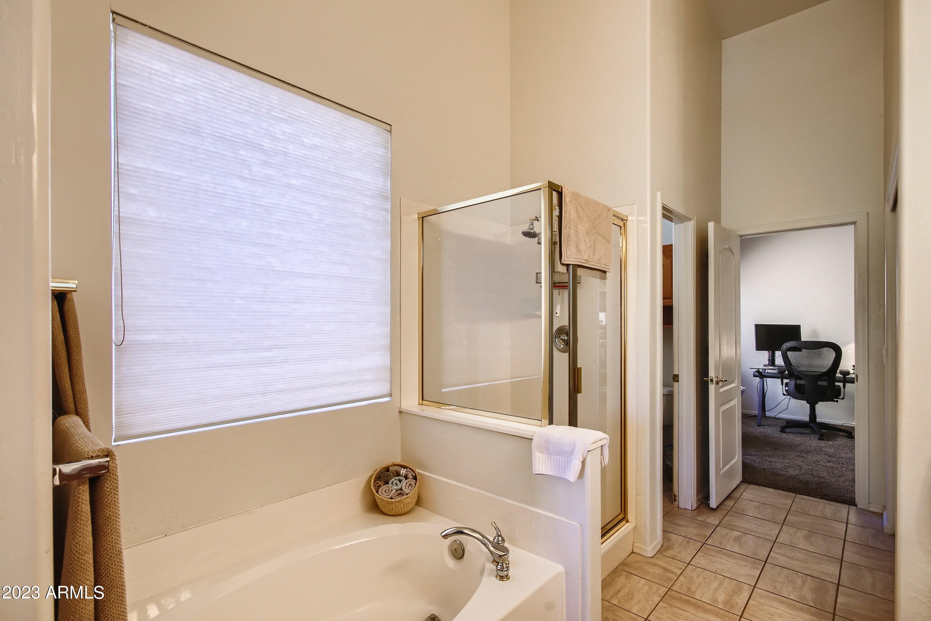 3060 North Ridgecrest, Unit 175 Mesa, AZ 85207 - Photo 20 of 28 a bathroom with a tub and a shower