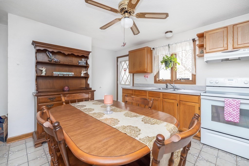 140 North Monson Road Hampden, MA 01036 - Photo 18 of 29 a room with stainless steel appliances kitchen island granite countertop a table chairs in it and wooden floor
