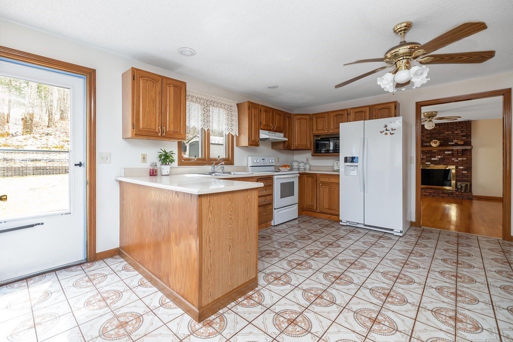 140 North Monson Road Hampden, MA 01036 - Photo 5 of 29 a kitchen with stainless steel appliances granite countertop a stove a sink a refrigerator and cabinets