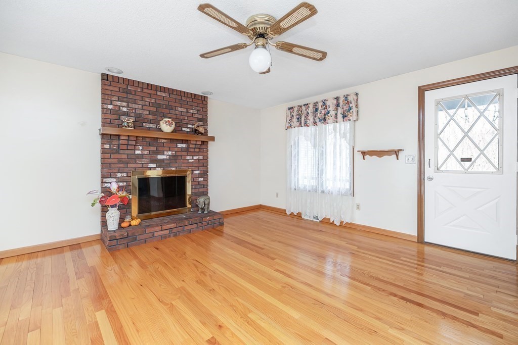 140 North Monson Road Hampden, MA 01036 - Photo 7 of 29 a view of empty room with fireplace and wooden floor