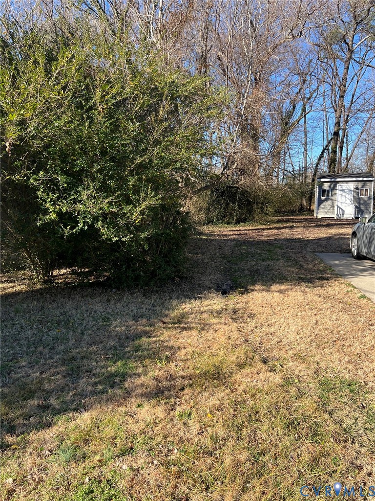 73-0760 Boston Street Hopewell, VA 23860 - Photo 2 of 5 a view of backyard with wooden fence and large trees