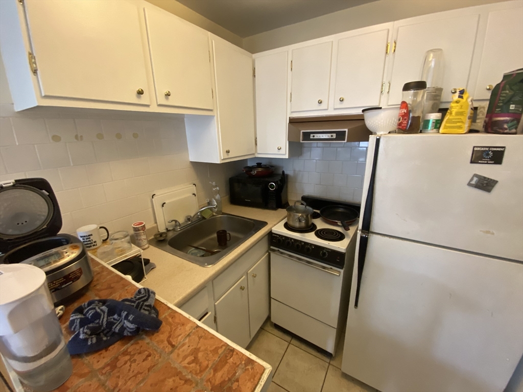 712 Commonwealth Avenue, Unit 2 Boston, MA 02215 - Photo 12 of 13 a kitchen with a stove and a refrigerator