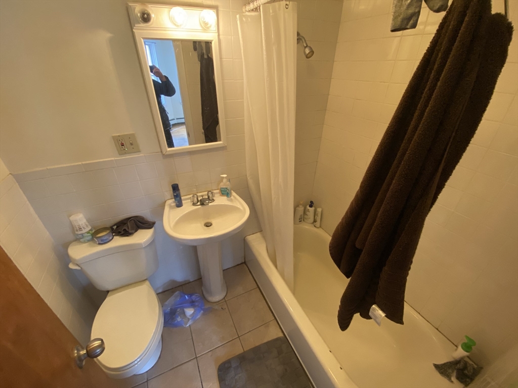 712 Commonwealth Avenue, Unit 2 Boston, MA 02215 - Photo 13 of 13 a bathroom with a toilet sink and mirror