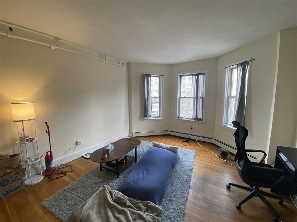 712 Commonwealth Avenue, Unit 2 Boston, MA 02215 - Photo 2 of 13 a room with gym equipment and a window