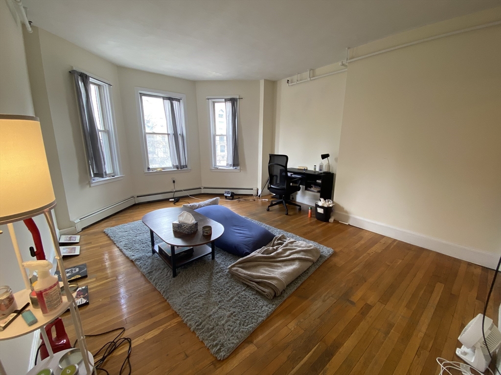 712 Commonwealth Avenue, Unit 2 Boston, MA 02215 - Photo 3 of 13 a living room with furniture and a window