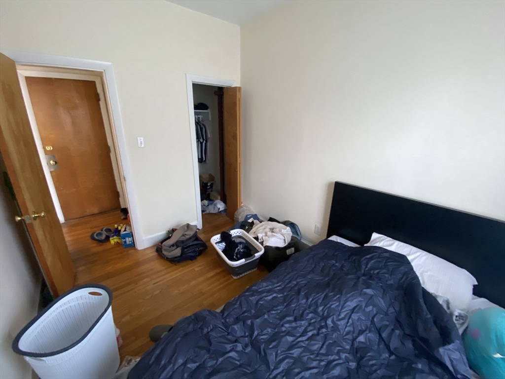 712 Commonwealth Avenue, Unit 2 Boston, MA 02215 - Photo 7 of 13 a bedroom with a bed and wooden floor