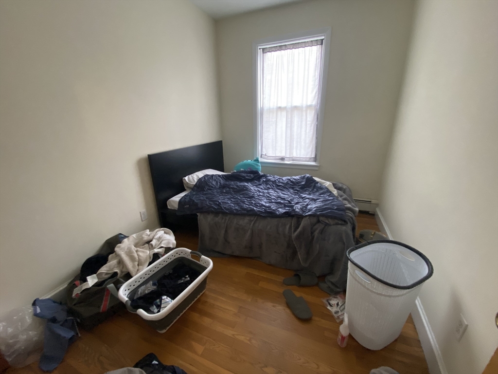 712 Commonwealth Avenue, Unit 2 Boston, MA 02215 - Photo 9 of 13 a bedroom with a bed and a window