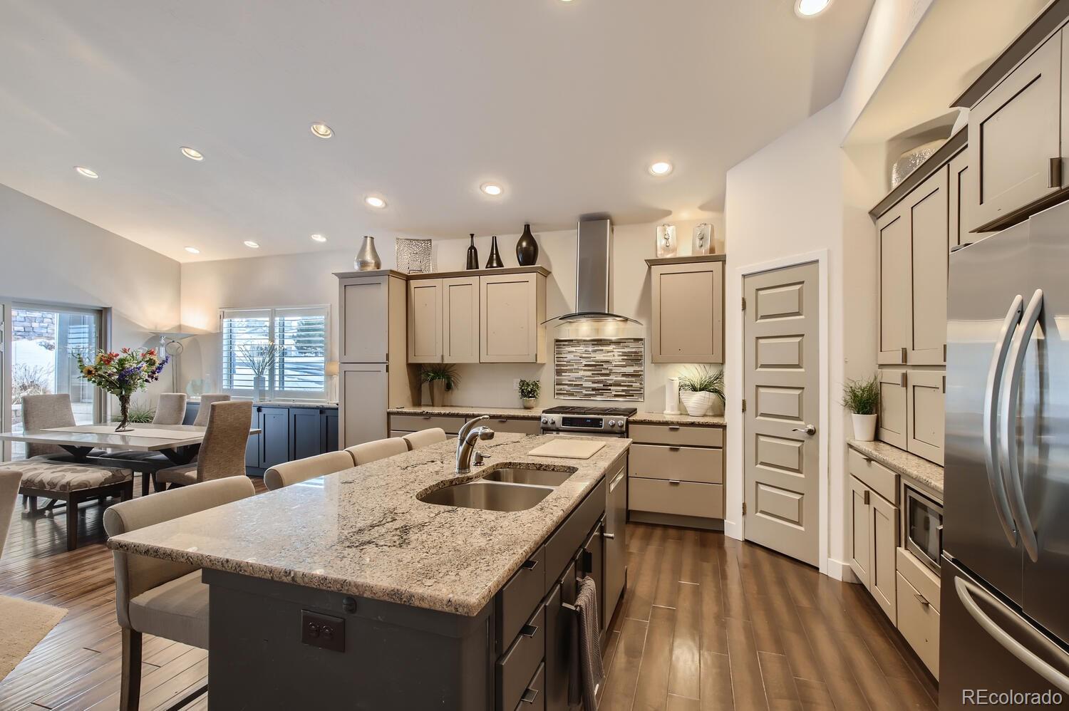 a kitchen with a center island appliances and cabinets