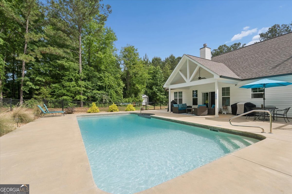 683 Teagle Road Forsyth, GA 31029 - Photo 35 of 50 a view of a house with swimming pool and sitting area