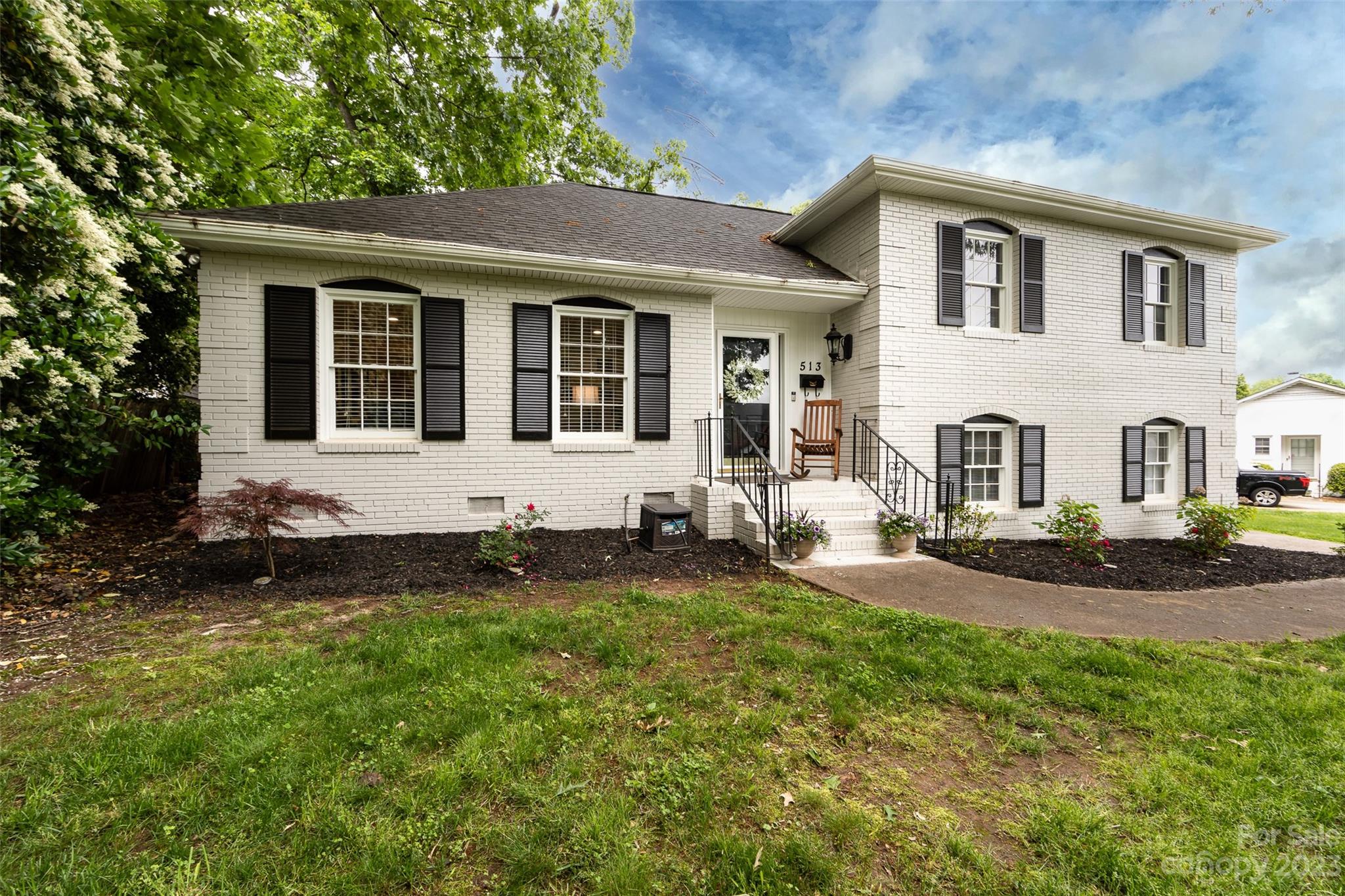 a front view of a house with garden