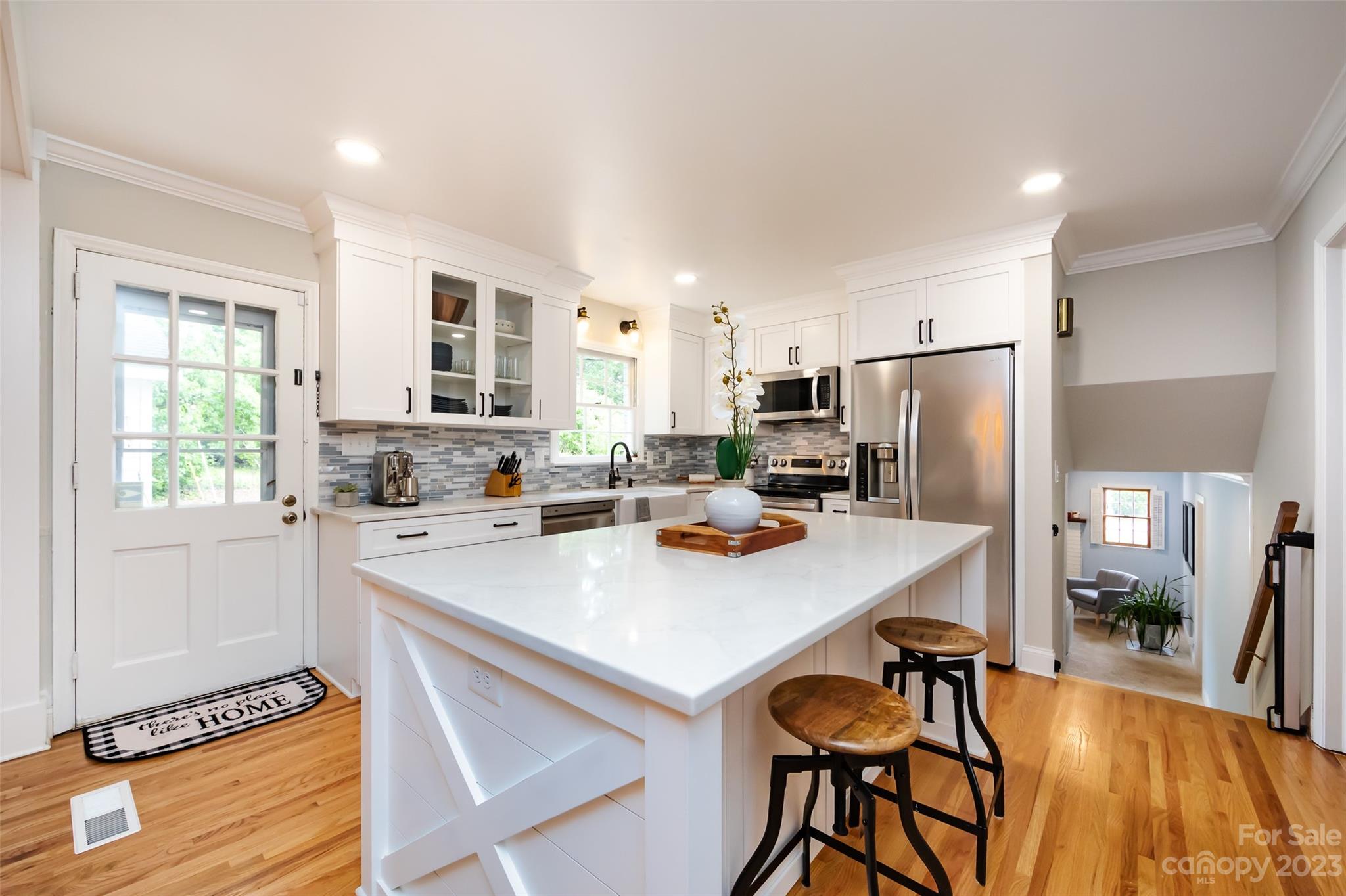 513 Sandridge Road Charlotte, NC 28210 - Photo 12 of 32 a kitchen with stainless steel appliances a stove a refrigerator a sink dishwasher and a refrigerator with wooden floor