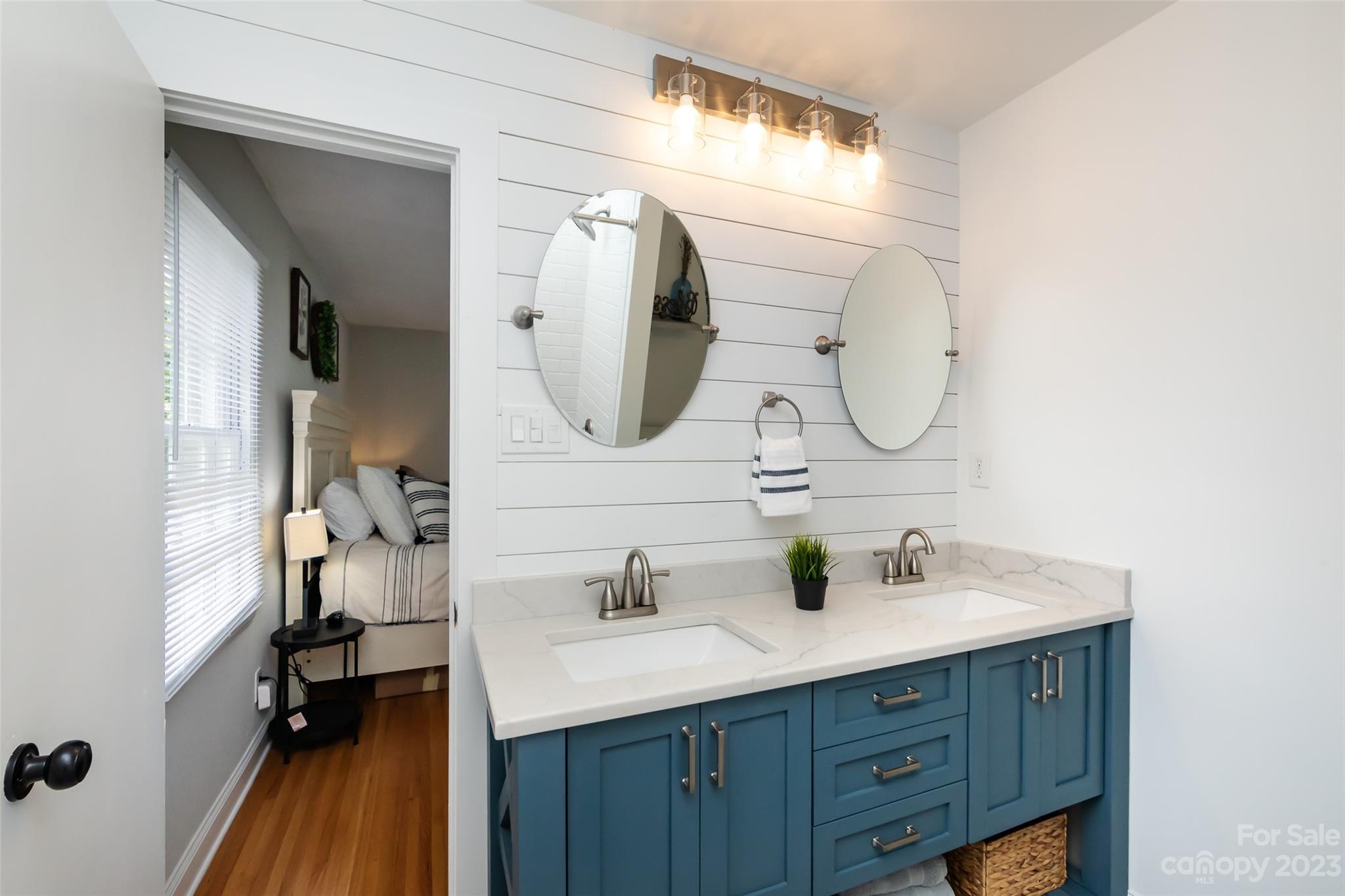 513 Sandridge Road Charlotte, NC 28210 - Photo 16 of 32 a bathroom with a double vanity sink and a mirror