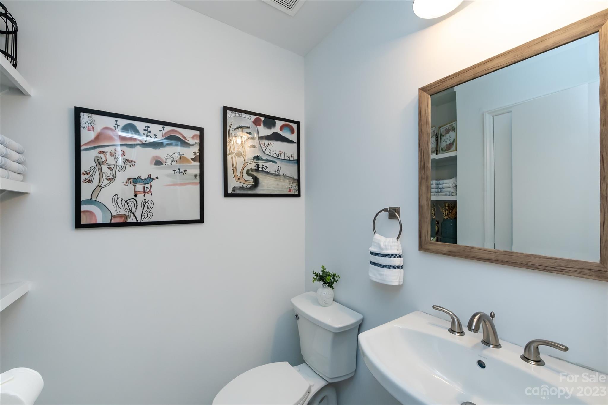 513 Sandridge Road Charlotte, NC 28210 - Photo 20 of 32 a bathroom with a toilet a sink and mirror