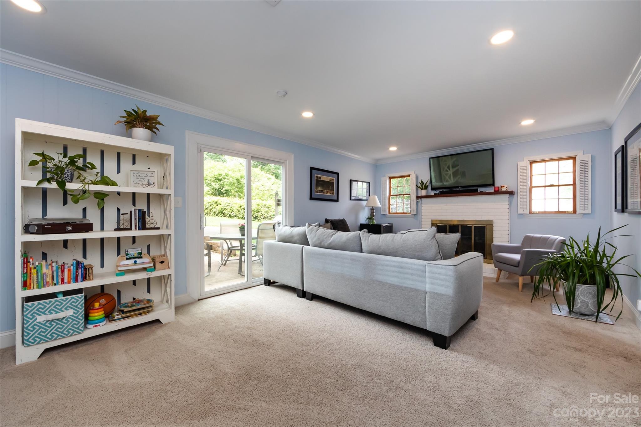 513 Sandridge Road Charlotte, NC 28210 - Photo 22 of 32 a living room with furniture a bookshelf and a window