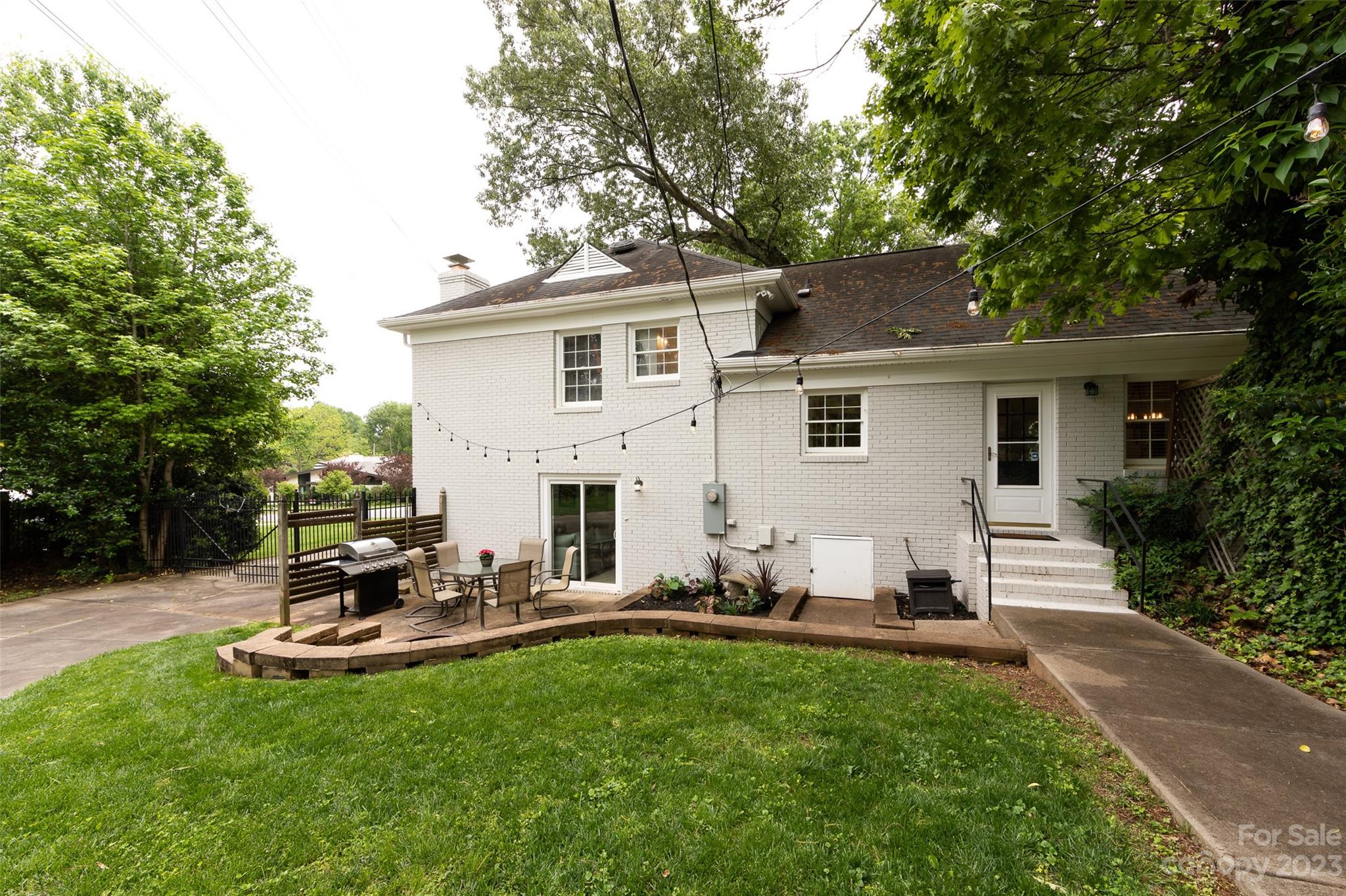 513 Sandridge Road Charlotte, NC 28210 - Photo 30 of 32 a house view with a garden space and a car parked