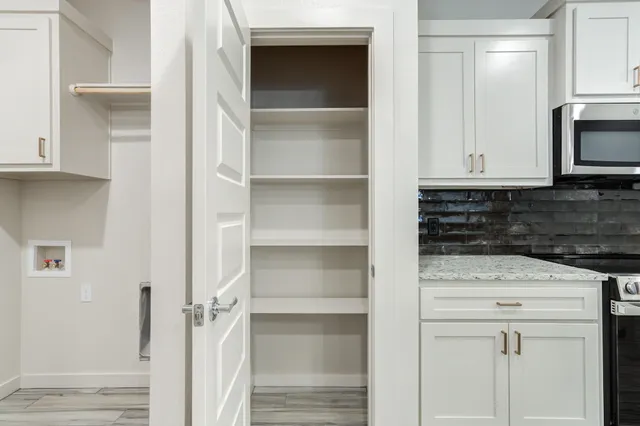 a kitchen with white cabinets and a sink