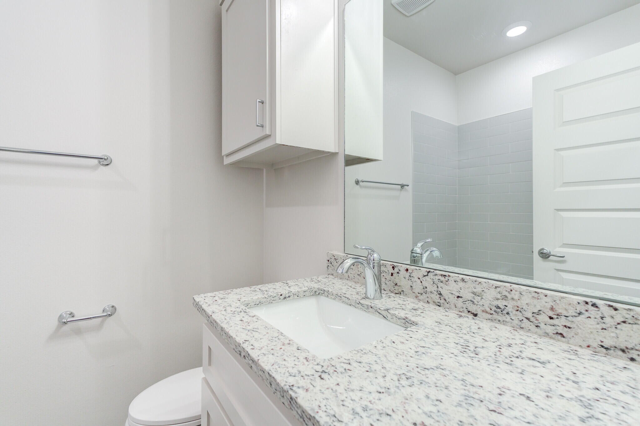 7048 41st Street Lubbock, TX 79407 - Photo 24 of 34 a bathroom with a granite countertop sink and a toilet