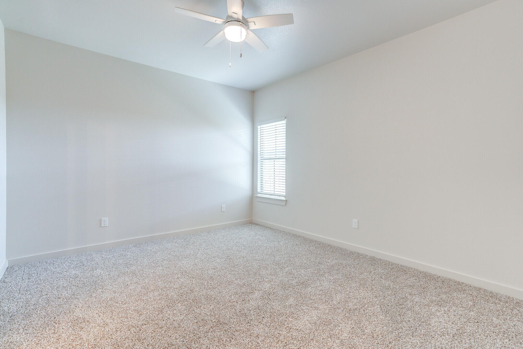 7048 41st Street Lubbock, TX 79407 - Photo 26 of 34 an empty room with a window and chandelier fan