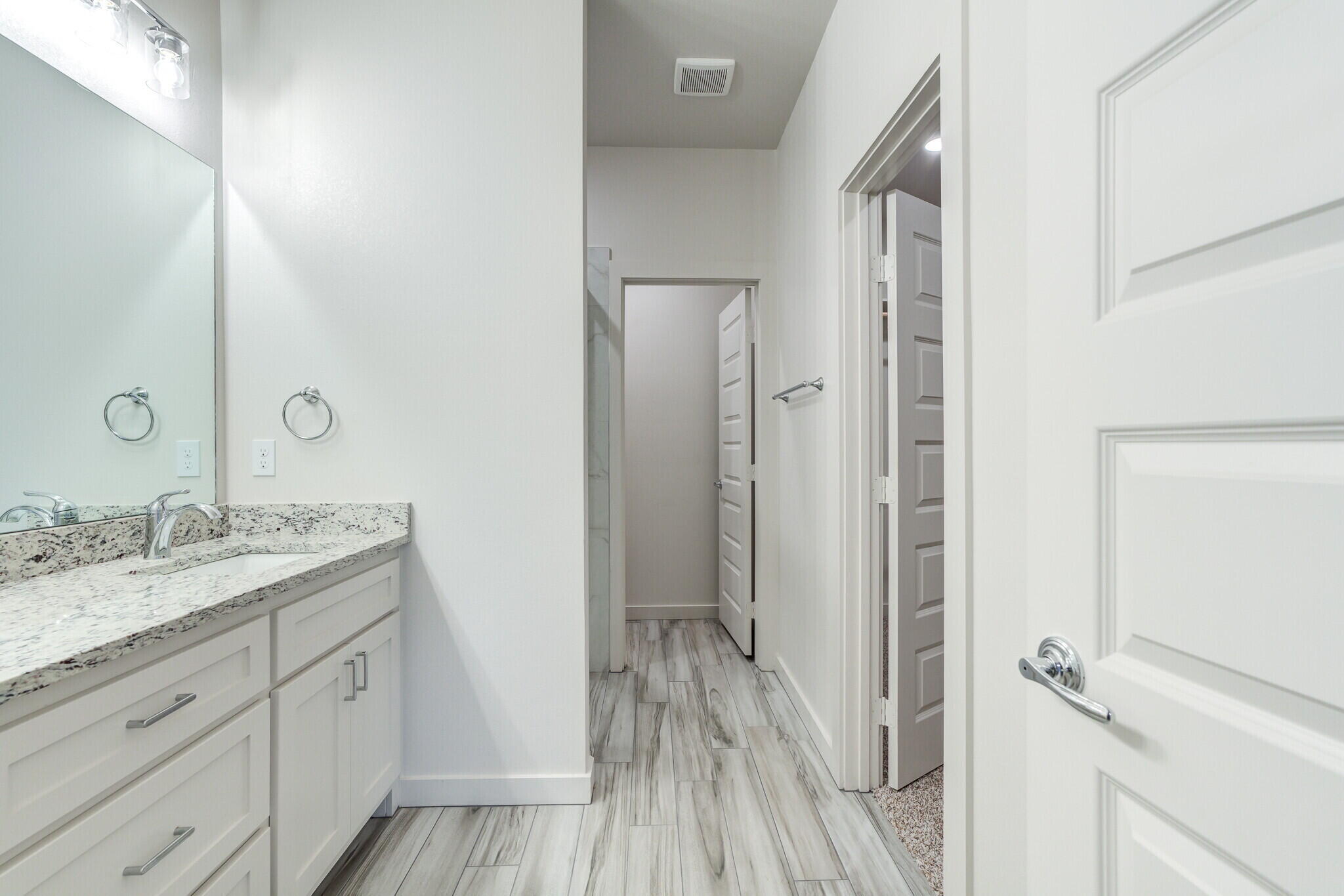 7048 41st Street Lubbock, TX 79407 - Photo 29 of 34 a bathroom with a granite countertop sink toilet and shower