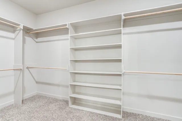 a view of walk in closet with empty racks