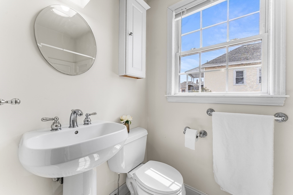 30 Russell Street, Unit 5 Waltham, MA 02453 - Photo 13 of 26 a bathroom with a sink a mirror and a toilet