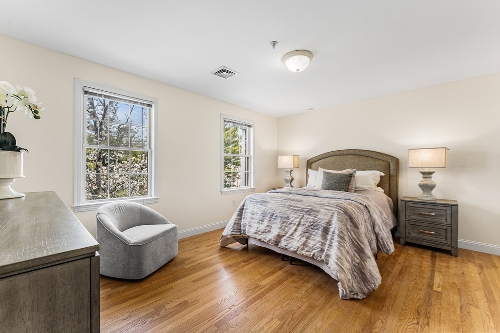 30 Russell Street, Unit 5 Waltham, MA 02453 - Photo 15 of 26 a bedroom with a bed and couch with window