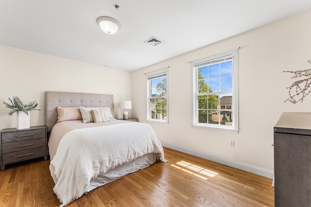 30 Russell Street, Unit 5 Waltham, MA 02453 - Photo 17 of 26 a bedroom with a bed and a window