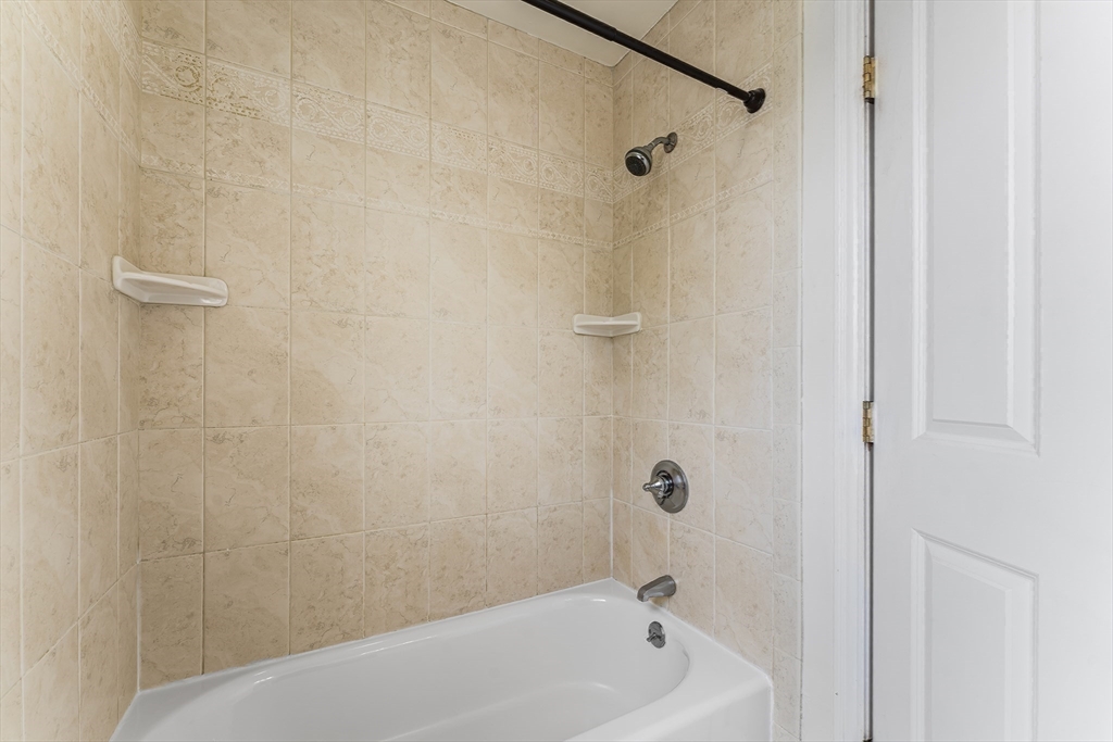 30 Russell Street, Unit 5 Waltham, MA 02453 - Photo 20 of 26 a bathroom with a bathtub
