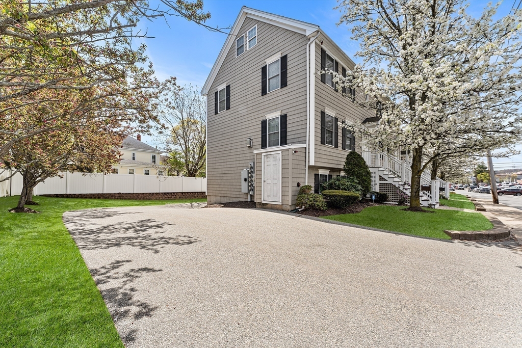 30 Russell Street, Unit 5 Waltham, MA 02453 - Photo 2 of 26 a view of a white house with a yard