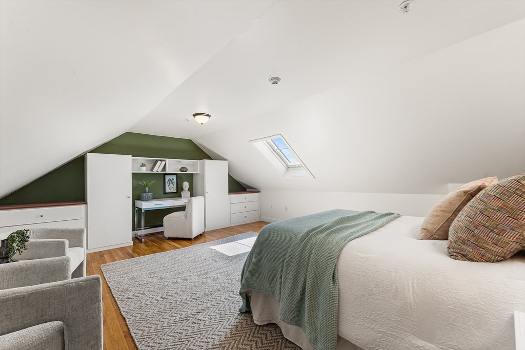 30 Russell Street, Unit 5 Waltham, MA 02453 - Photo 21 of 26 a bedroom with a bed and a night stand