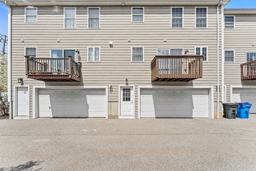 30 Russell Street, Unit 5 Waltham, MA 02453 - Photo 23 of 26 a front view of a house with a garage