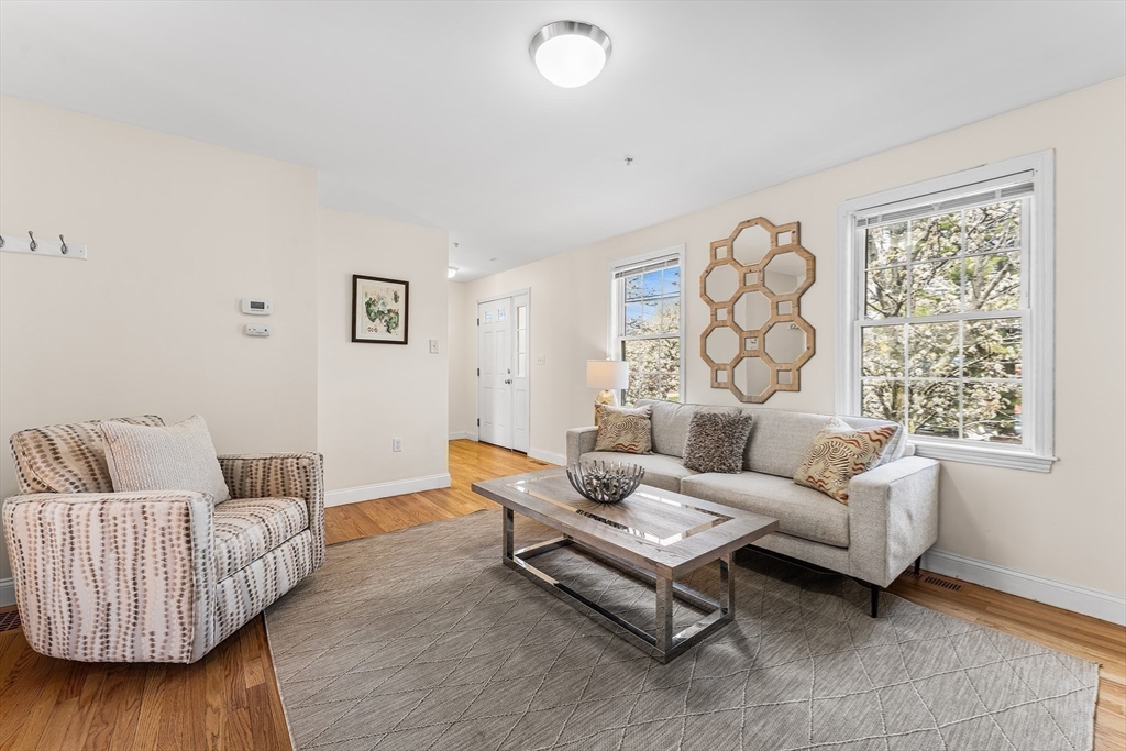 30 Russell Street, Unit 5 Waltham, MA 02453 - Photo 5 of 26 a living room with furniture and a large window