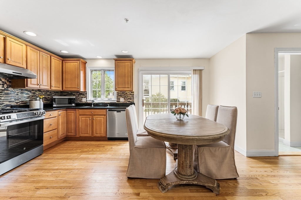 30 Russell Street, Unit 5 Waltham, MA 02453 - Photo 7 of 26 a kitchen with a stove a sink and a refrigerator