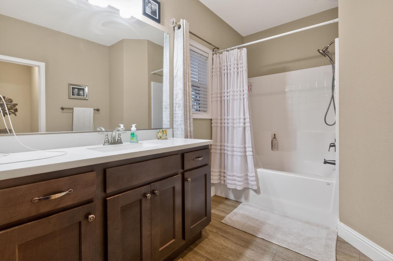 7570 Airola Road Vallecito, CA 95251 - Photo 62 of 90 a bathroom with a double vanity sink a mirror a bathtub and shower