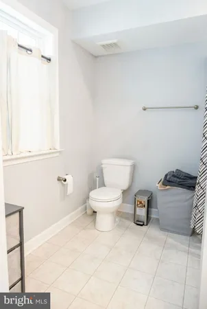 a white toilet sitting next to a bathroom sink