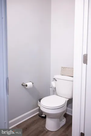a white toilet sitting next to a shower