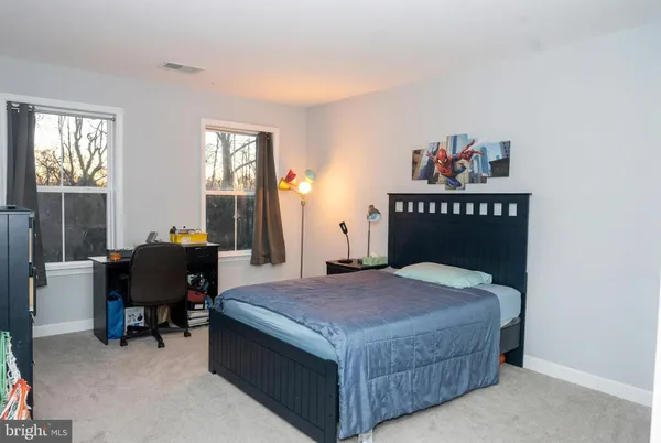 a bedroom with a bed and wooden furniture