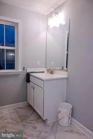 a bathroom with a sink vanity and a mirror