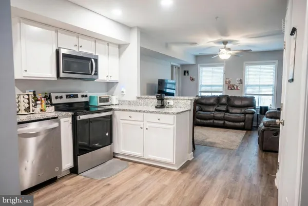 a kitchen with a refrigerator stove and sink