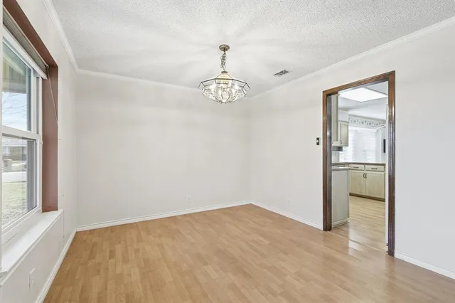 a view of a room with wooden floor and a window