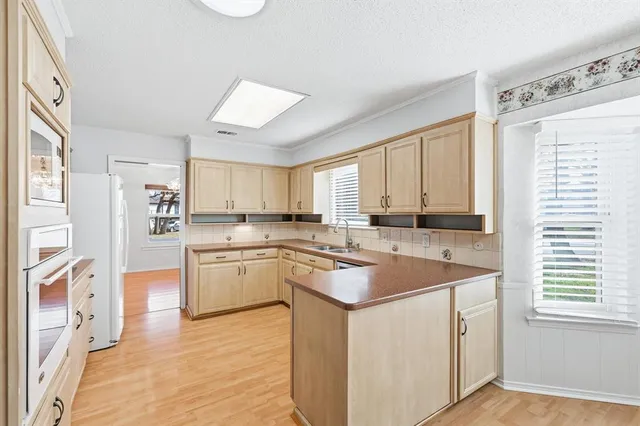 a kitchen with a stove a sink and a refrigerator