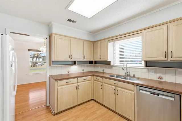 a kitchen with a sink stove and cabinets