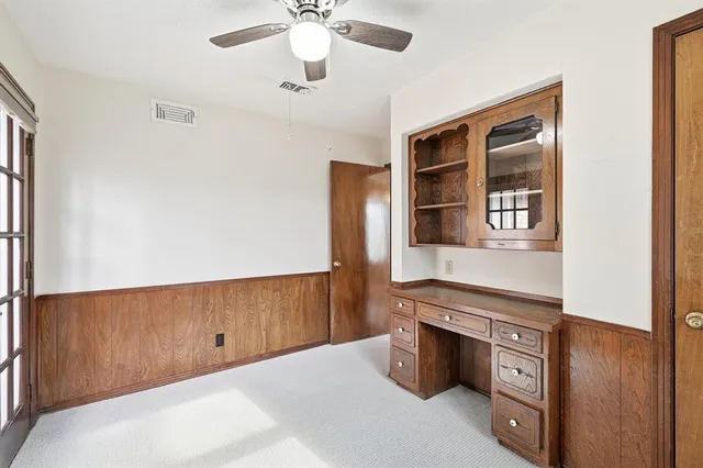 a view of an empty room with window and cabinet