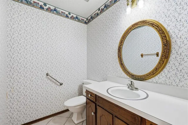 a bathroom with a sink mirror vanity and toilet