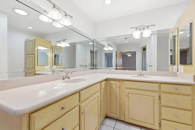 a bathroom with a sink vanity and mirror