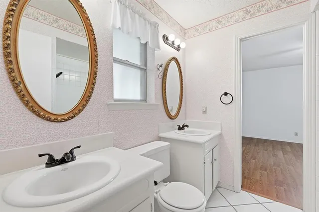 a bathroom with a sink a toilet and a mirror