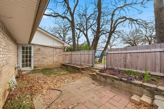 a backyard of a house with plants and trees