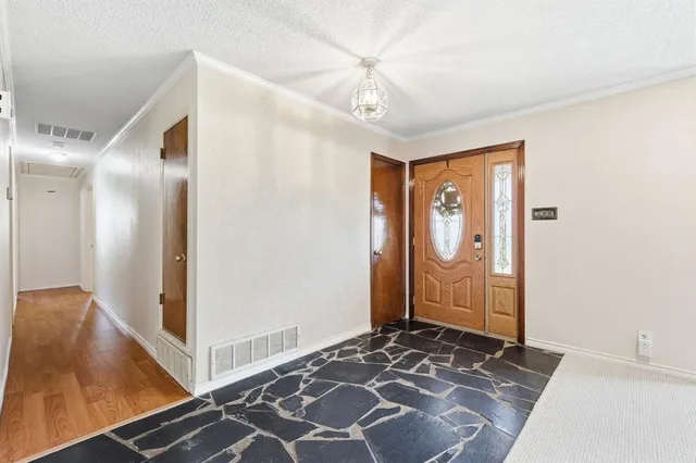 a bedroom with bed and hardwood