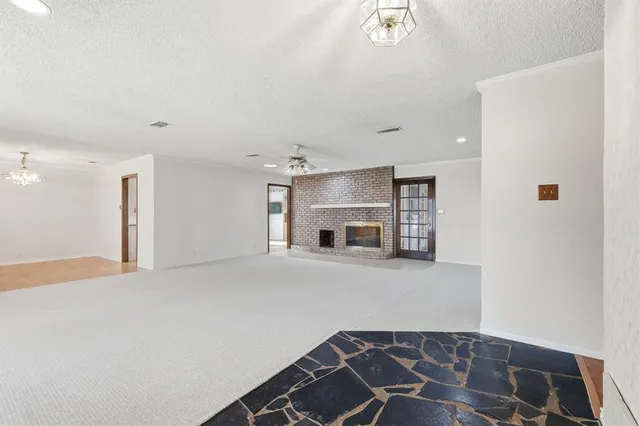 a view of an empty room with a fireplace