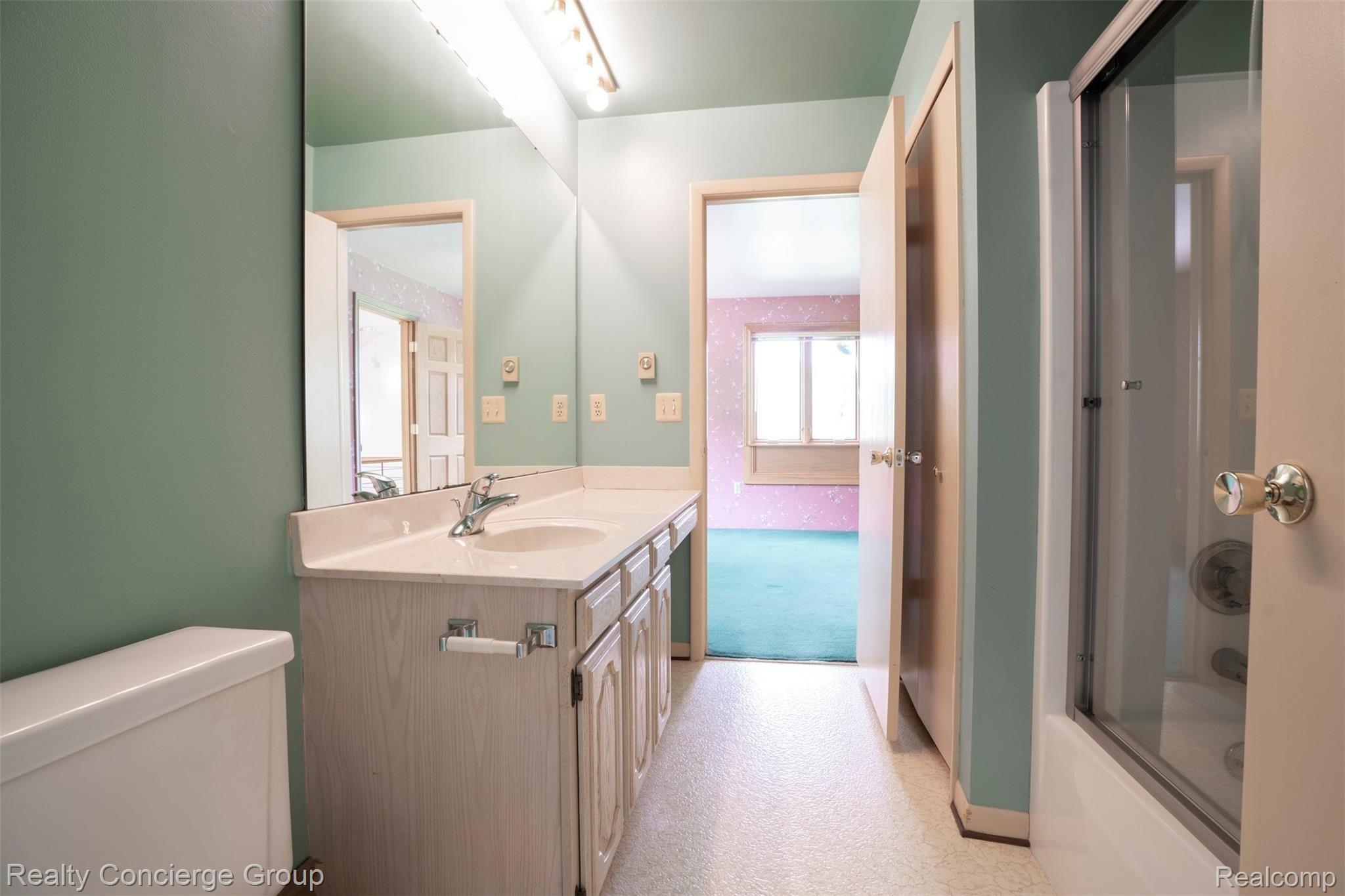2110 East Clyde Road Howell, MI 48855 - Photo 15 of 44 Jack and Jill bath is open and spacious, has long counters, cabinets and tub/shower
